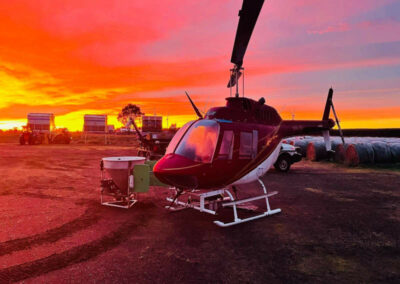 agricultural helicopter at sunset