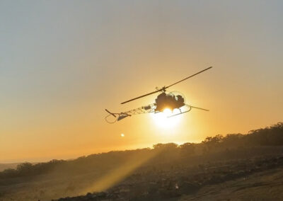 helicopter flying into the sunset