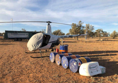 helicopter next to barrels